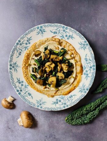 Heerlijke hartige en glutenvrije gevulde pannenkoeken met cashew dressing, gewokte palmkool en gebakken champignons. Een verrassend vegetarisch hoofdgerecht.